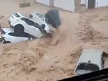 Flash floods kill 102-year-old woman and leave 90 having to be rescued as they sweep through Spanish town