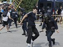 Spanish protests against holidaymakers explode into violence as riot police charge fence-hurling demonstrators amid fight for tax hikes on tourist apartments