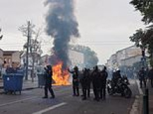 Boy, 15, held for burning woman with makeshift flame-thrower in riots