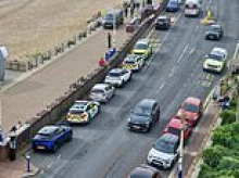 Body of woman 'wearing a wetsuit' is found washed up on popular beach a day after coastguard were seen scouring the area