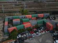 Shipping container village hailed as a 'dream for all homeless people' is making life a 'living hell' for neighbours - who claim residents are trespassing on their £500,000 properties and women are too scared to go out alone