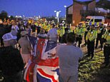 Anti-migrant protesters scuffle with police after nearly 150 small boat arrivals use 'new route' to land at historic naval port