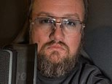 Mystery men hijack court video to spray foul-mouthed attack on the mother of accused crime reporter Ryan Naumenko as hearing descends into chaos