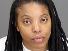 Female cop looks glassy-eyed in mugshot after she allegedly drove drunk wrong way down road and crashed into car
