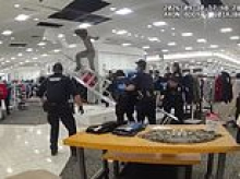 Scary moment man being sought by police hid in ceiling of mall... only to come crashing through it onto floor