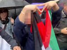 Protester is spotted making 'pro-Hamas' triangle sign on October 7 march after five were arrested for 'inciting racial hatred' outside Board of Deputies of British Jews