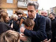 Ed Miliband embraces Ukrainians at scene of Putin bombing raid that killed 22 as Britain announces new sanctions on Russia