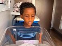 Little boy killed by falling electronic display board is pictured, as school tells family he was pushing it back and forth before it toppled on him