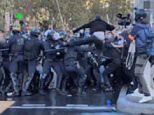 Moment French riot police violently clash with students in central Paris - as Muslim far-Left mayor at the forefront of protests poses with fans for selfies