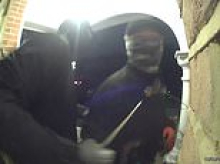 'Traveller' burglary squad strikes again: Terrifying moment balaclava-clad gang linked to 50 break-ins use crowbars to smash through front door of another London home