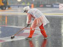 Think YOUR job is a thankless task? Funny moment Singapore workers try to defy the elements and sweep away torrential downpouring threatening the Grand Prix