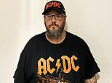 Troy Saxby waited 10 years to see AC/DC with his kids... and then got coward punched for standing during his favourite song. That was just the start of a 'nightmare' that landed him in court