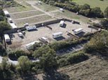 The traveller 'land grab' linked to Cambridge University: How Trinity College signed off £100,000 sale of land - which was then paved over and turned into caravan site