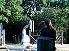 Children are seen doing handstands and playing chicken with high speed trains - forcing busy level crossing to close