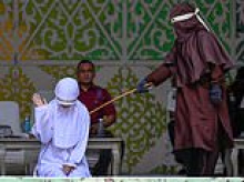 Woman collapses after being caned for sex outside marriage in breach of Sharia law in Indonesia