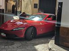 Farce and furious: Ferrari owner is left fuming when he gets his supercar stuck in a narrow alley