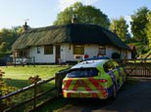 Man's body is found in garden of £800,000 detached house with thatched roof in 'friendly' village as police probe 'unexplained' death