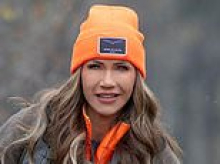Self-confessed dog-killer Kristi Noem panned for posting hunting picture in full hair and makeup with pup commenters say looks 'petrified'