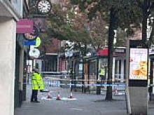 Police officer rushed to hospital after being shot in city centre - as police launch search for man and woman