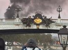 Moment tour guide leads group of holidaymakers on river boat through Paris as city burns and sirens blare in the riots