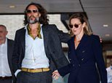 Russell Brand grinned 'like a clown' and told woman 'don't be a spoilsport' as he raped her in a toilet cubicle, court told