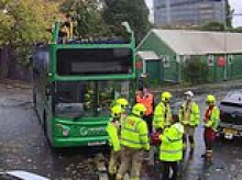 Three children hospitalised as double-decker bus has its roof torn off after crashing into railway bridge